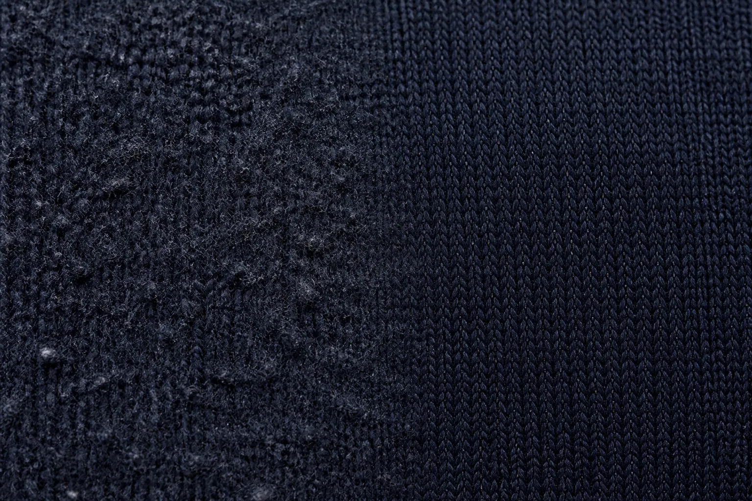 Close-up of navy knit: heavily pilled and fuzzy on the left, smooth and restored on the right